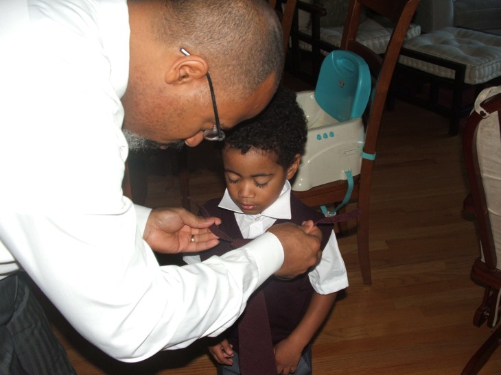 Lifting the collar, lining up the bulging knot, attaching the velcro lines